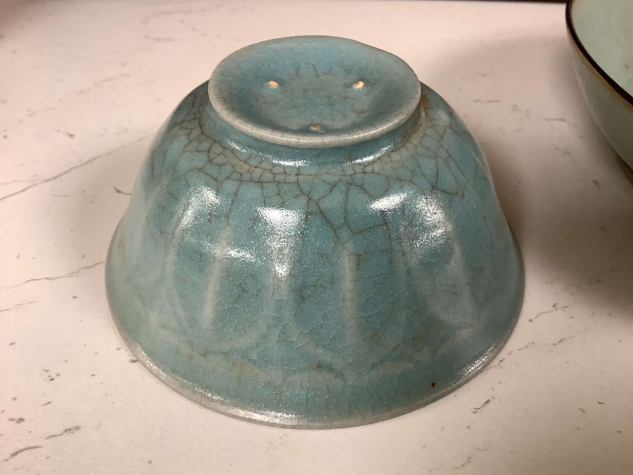 A Chinese celadon bowl and a teabowl, diameter 15cm